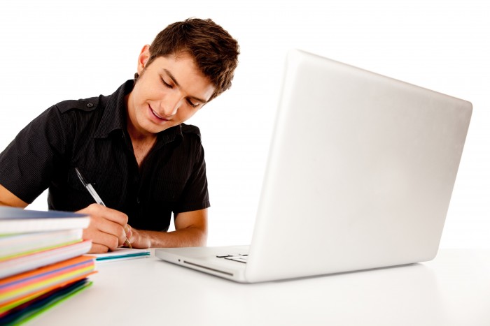 Happy male student with a laptop and notebooks Ð isolated
