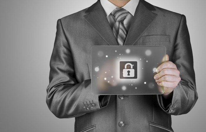 Businessman pushing virtual security button